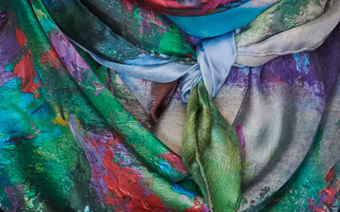 Close up of Reverie silk scarf by Oksana, tied, showing multitude of greens, blues, reds and other colors