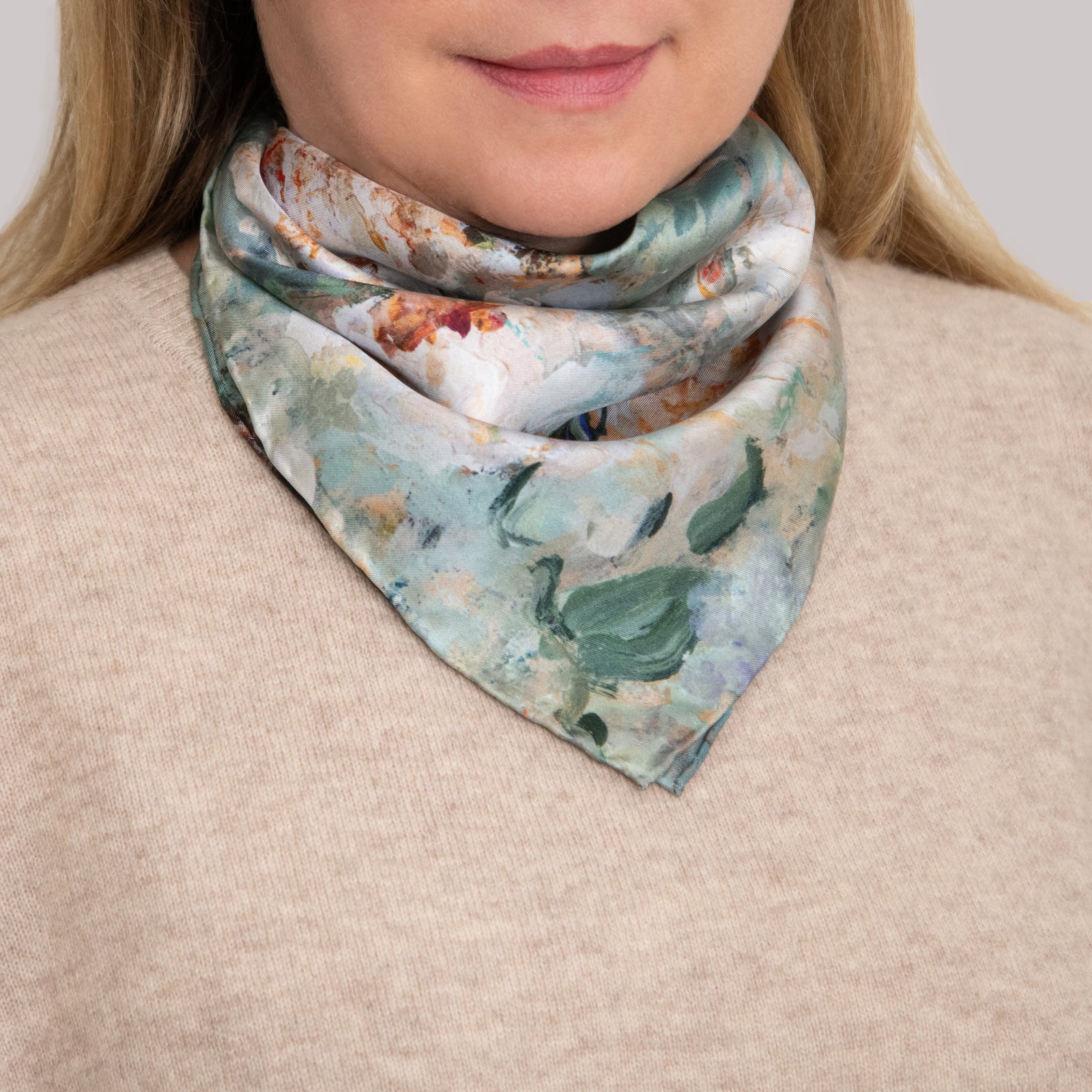 Woman in a beige sweater with a small silk scarf around her neck showing light green, white, and orange colors, based on an impressionistic oil painting by Oksana Johnson.