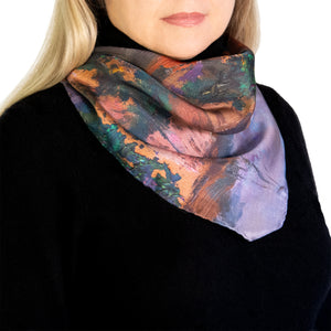 Twilight Reflections scarf showing orange and evening colors worn by model. 