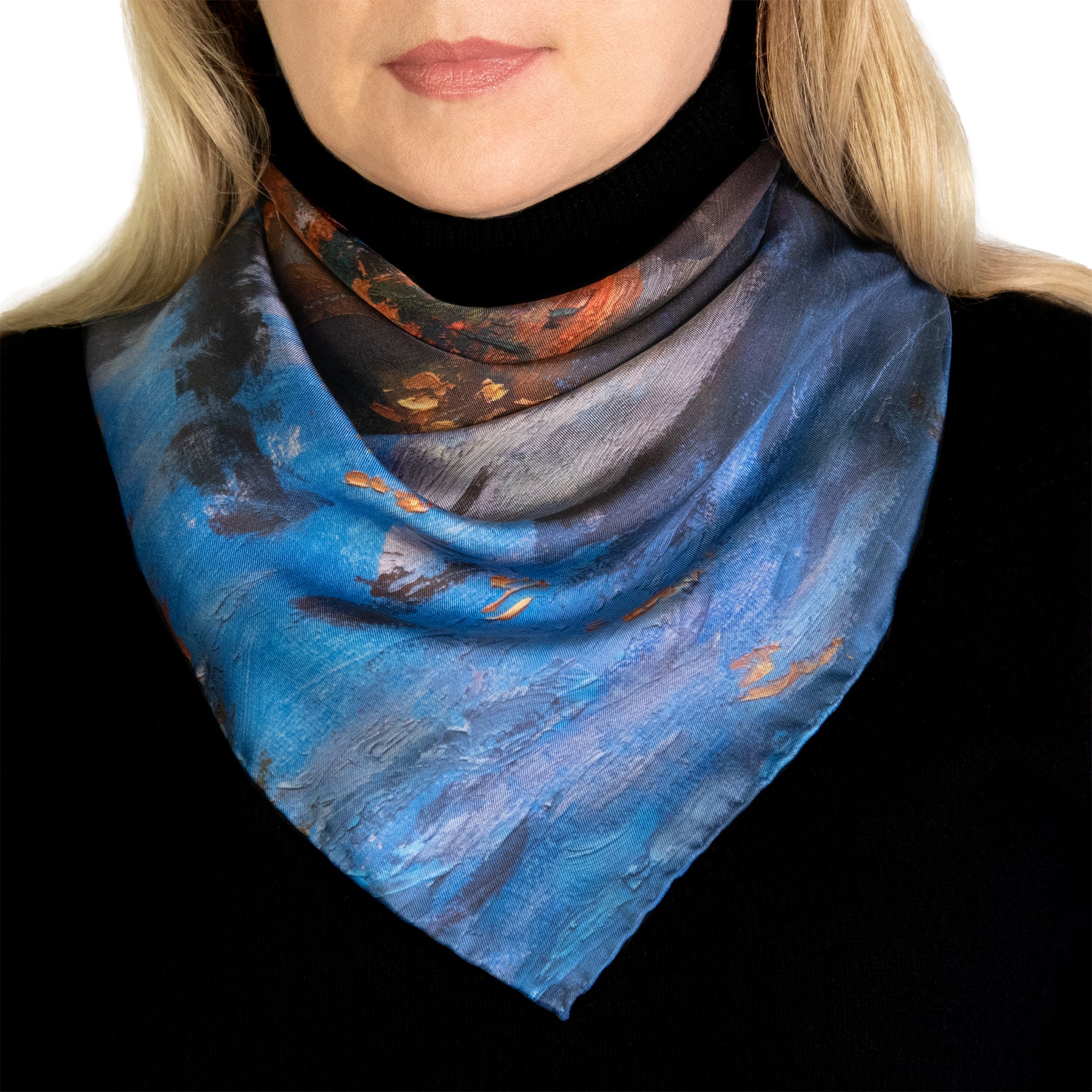 Twilight Reflections scarf showing artistic design in blue and orange worn by a person on a white background