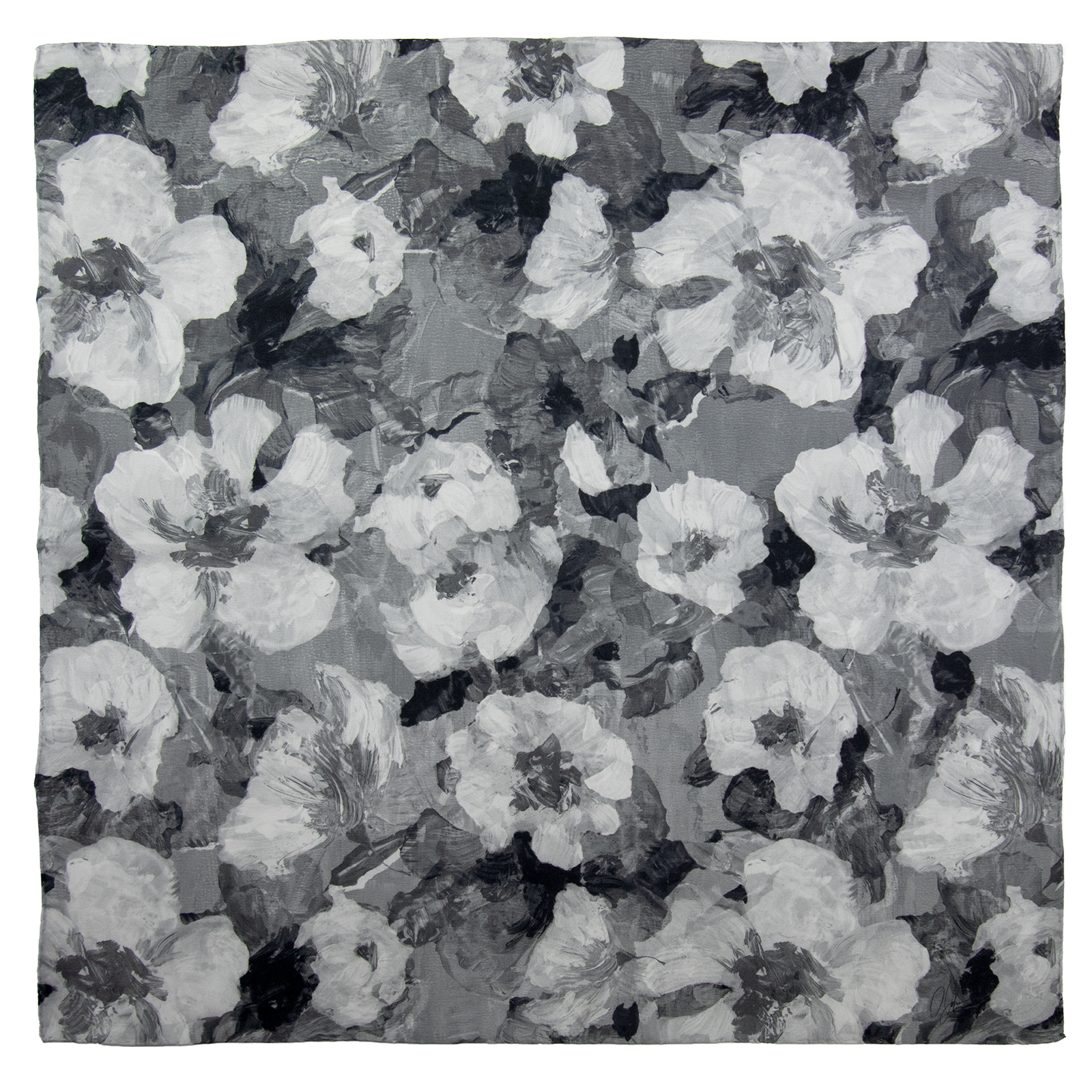 Woman wearing a medium-sized silk scarf in a floral pattern with black, white, and gray overlapping images and hand hemmed edges, along with a white coat and a black top. 