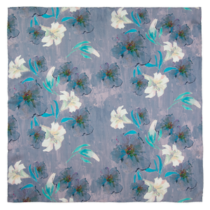 Square scarf with floral pattern including white lilies, with blue, and purple elements, hand hemmed edges. 